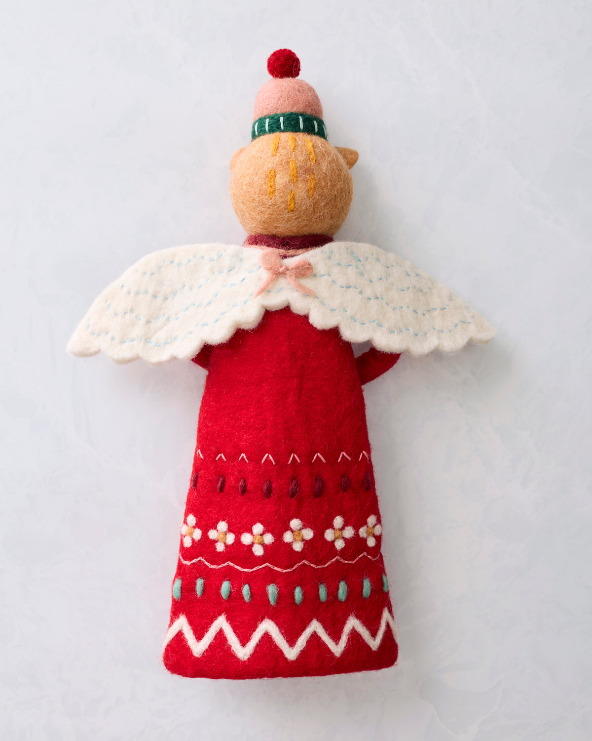 Back view of the red cat tree topper showing its white wings, winter hat, and plain red back.