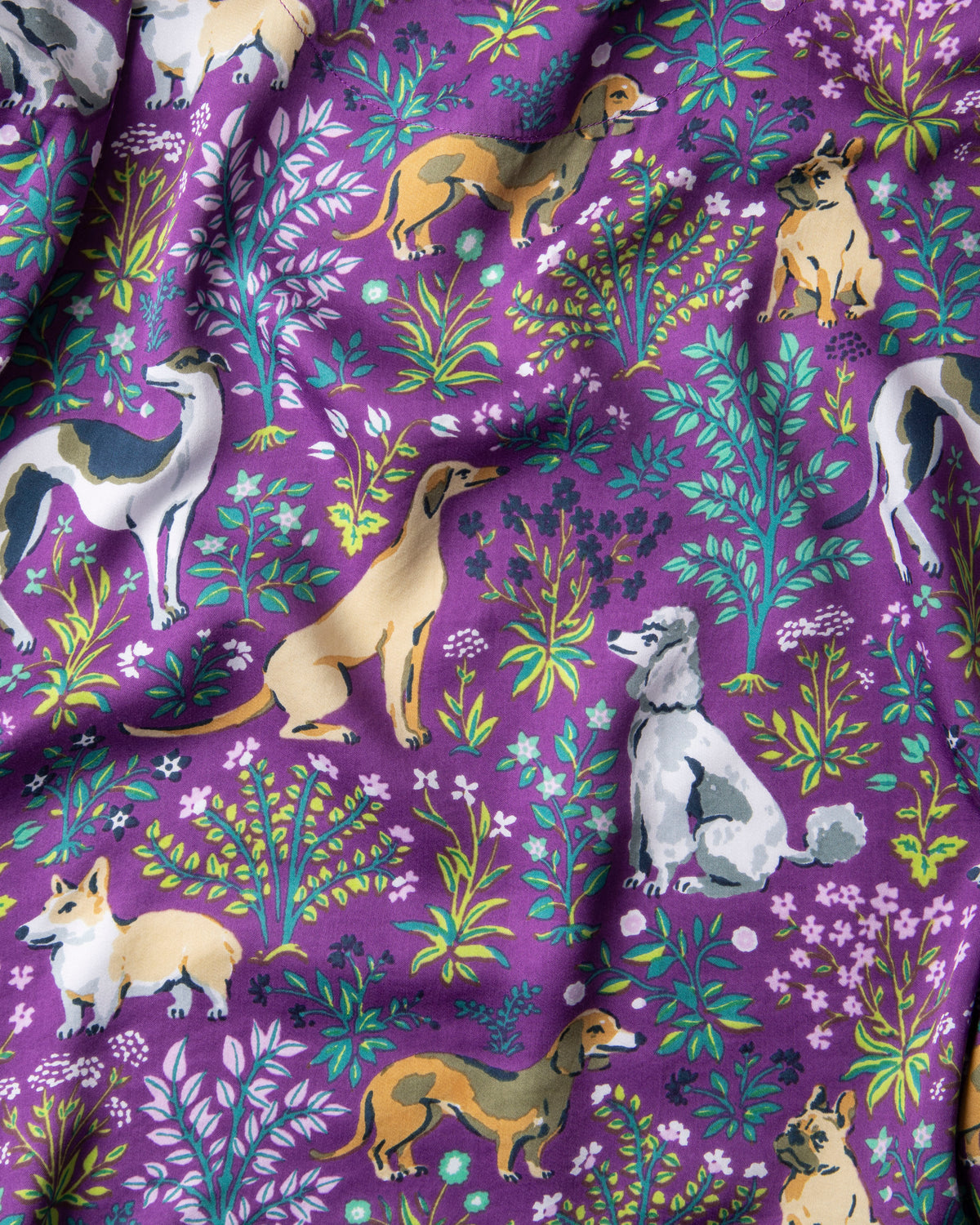 Amethyst fabric swatch with illustrated dogs and colorful botanical motifs.