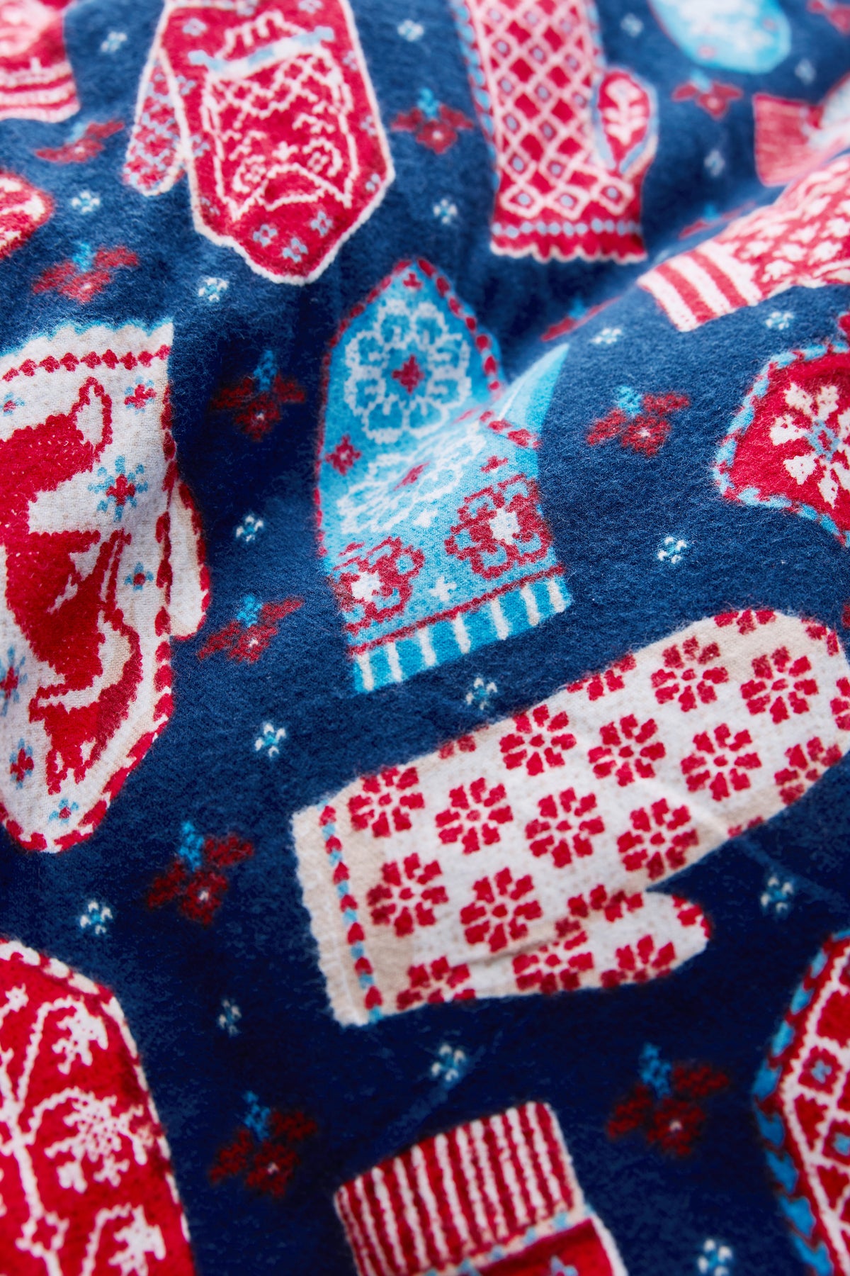 Close-up fabric swatch showing the Viking Blue Nordic Mittens pattern in blue, red, white, and light blue.