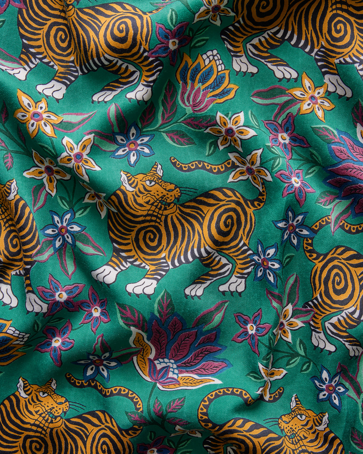 Close-up of the Royal Teal Tibetan Tigress print, with illustrated tigers, flowers, leaves, and birds.
