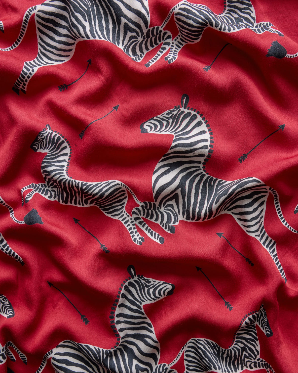 Close-up of the red zebra-and-arrow print used on the scrunchie.
