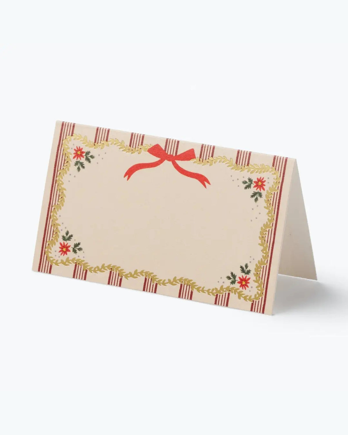 Folded holiday place card with a red bow, striped border, gold foliage, and small floral decorations.