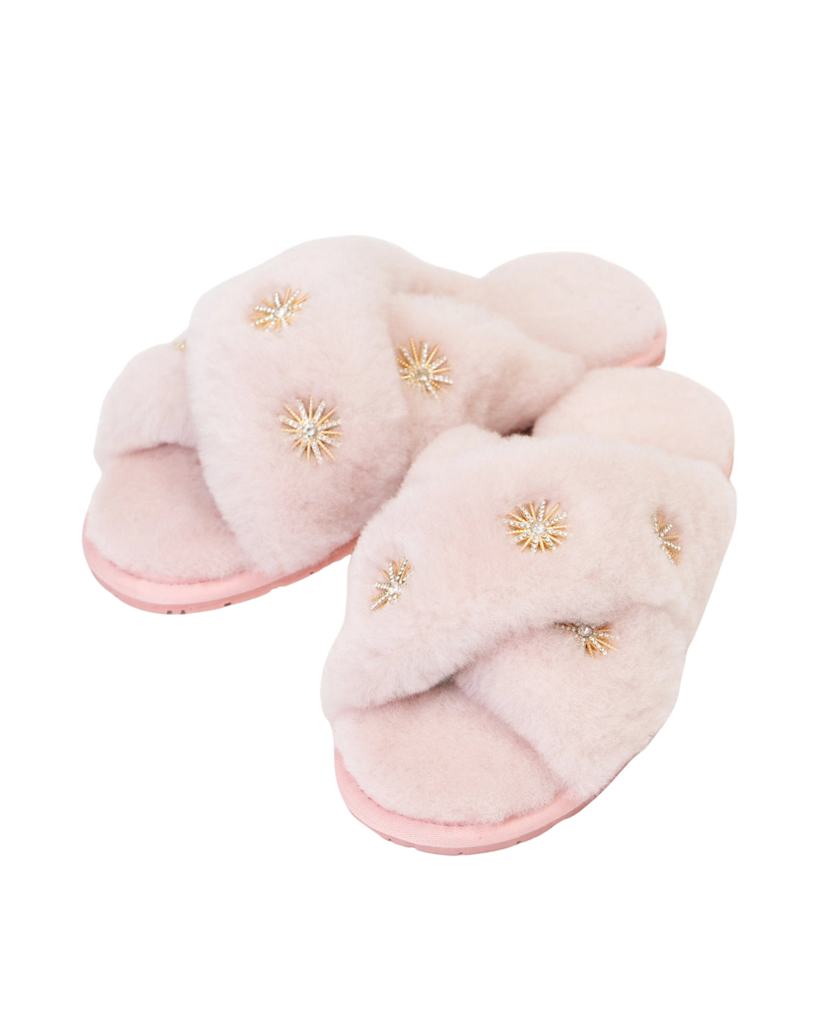 Pair of pink open-toe slippers with crossed plush straps and rhinestone embellishments, shown at an angle.