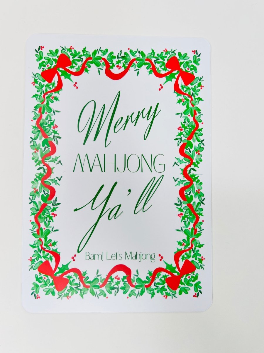 White Christmas Mahjong shuffler card with a leafy green and red ribbon border and the phrase “Merry Mahjong Y’all.”
