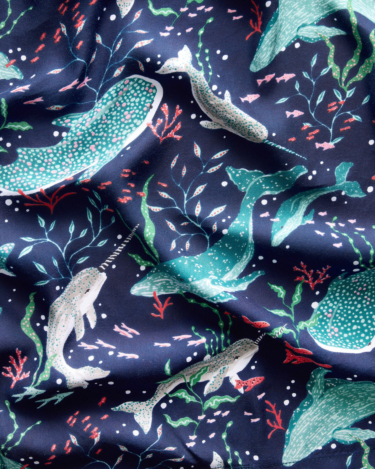 Close-up of the robe fabric showing a navy sealife print with whales, fish, aquatic plants, and coral shapes.