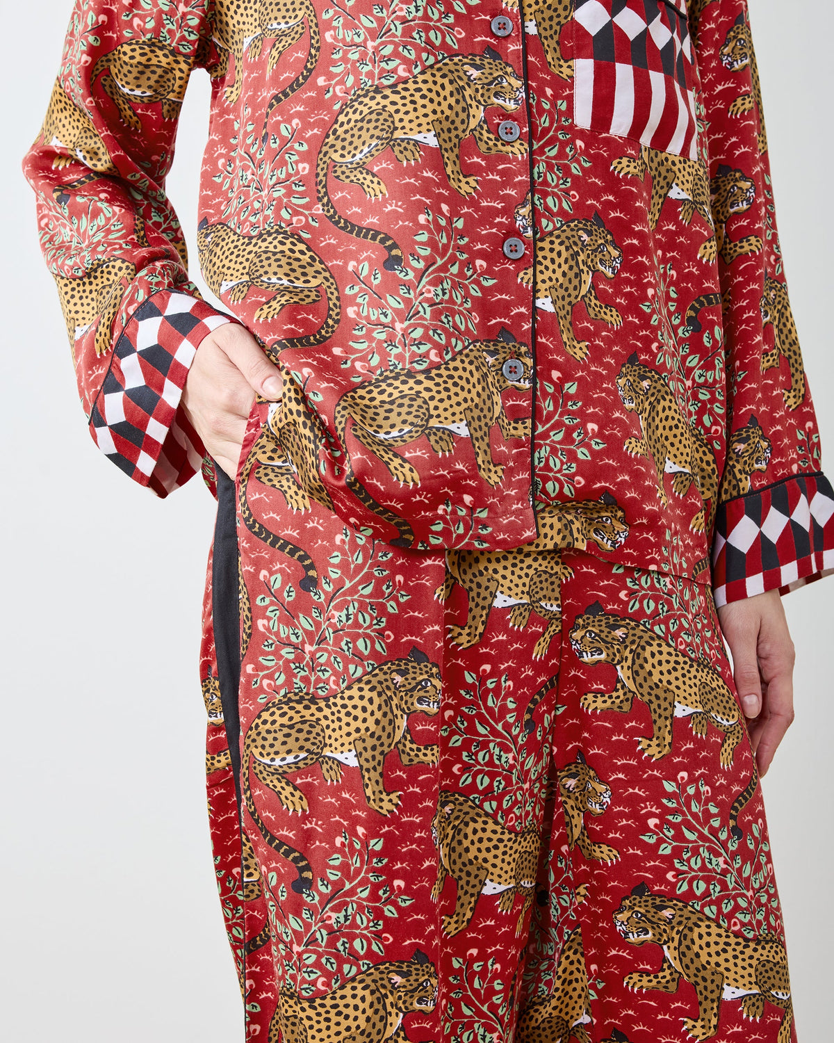 Close view of the scarlet Bagheera satin pajama top and pants with spotted big cat print and checked trim