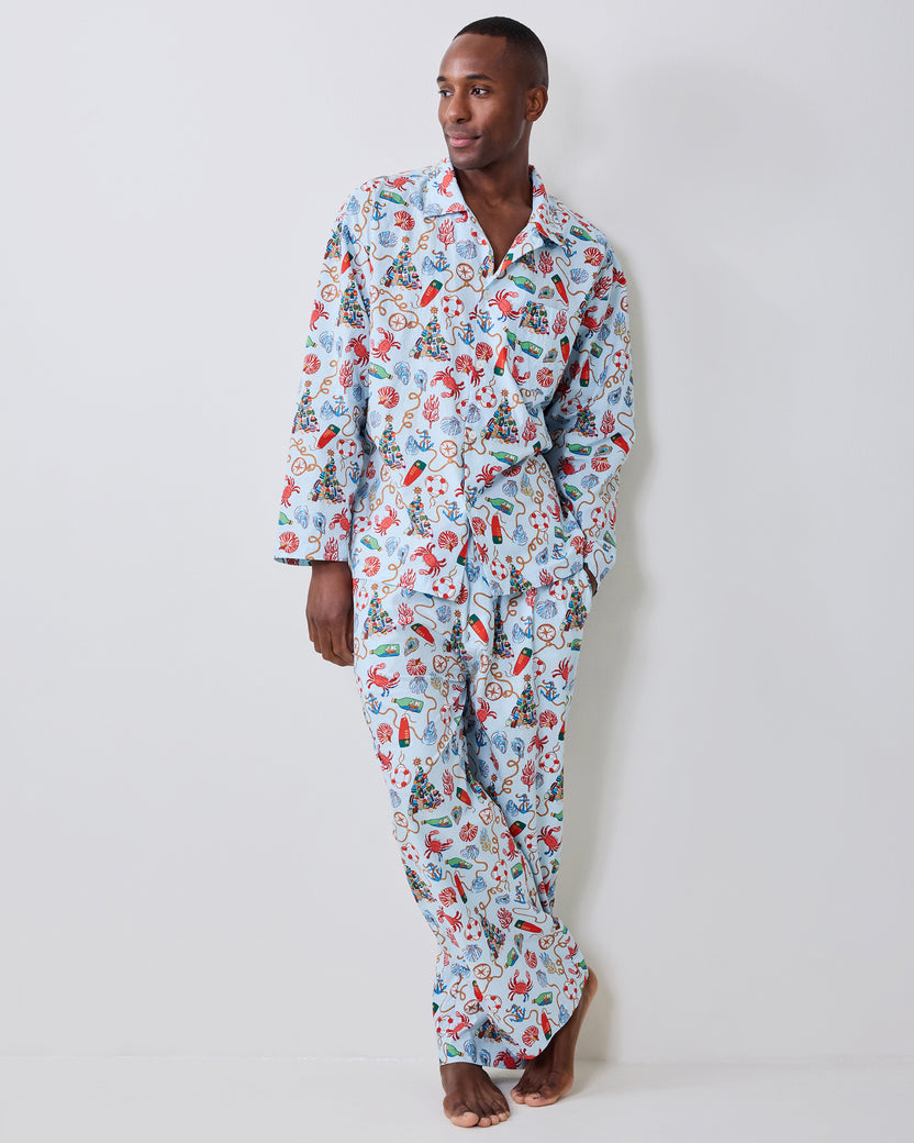 Front view of a model wearing the Holidays Ahoy long pajama set with a blue-and-white nautical Christmas print.