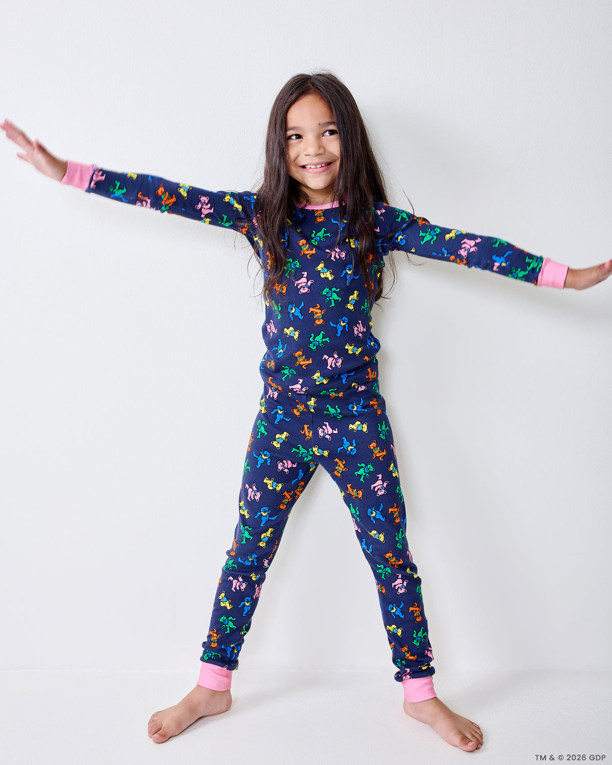 Child wearing the Dancing Bears kids pajama set with arms outstretched.