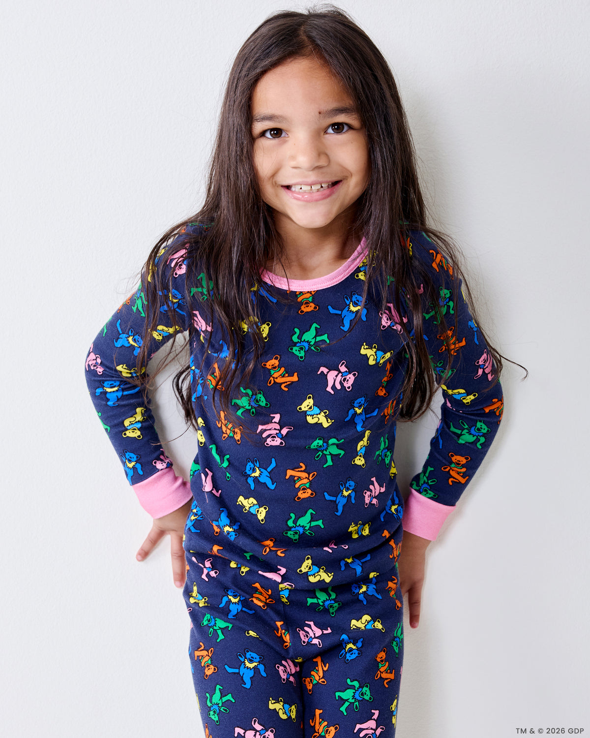 Child wearing the Dancing Bears kids snug fit long pajama set in Backstage Blue, standing against a light wall.