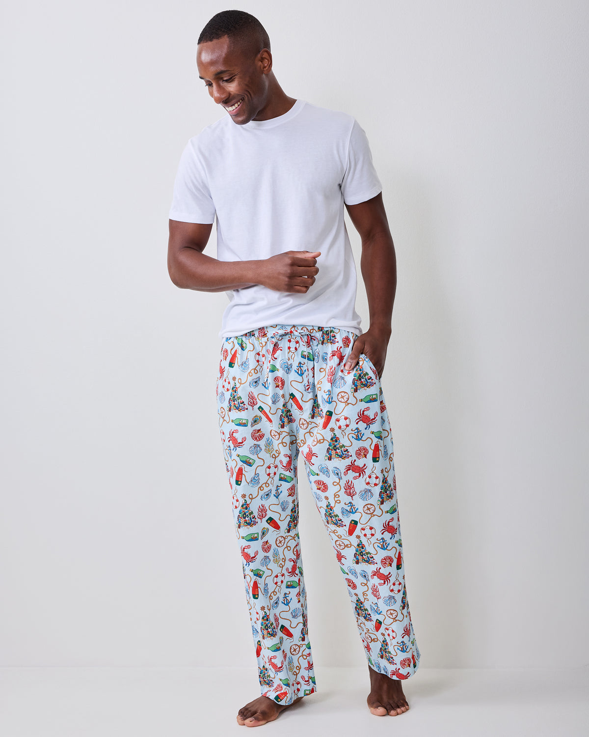 Full front view of the men's long pajama pants with a light blue nautical holiday print.