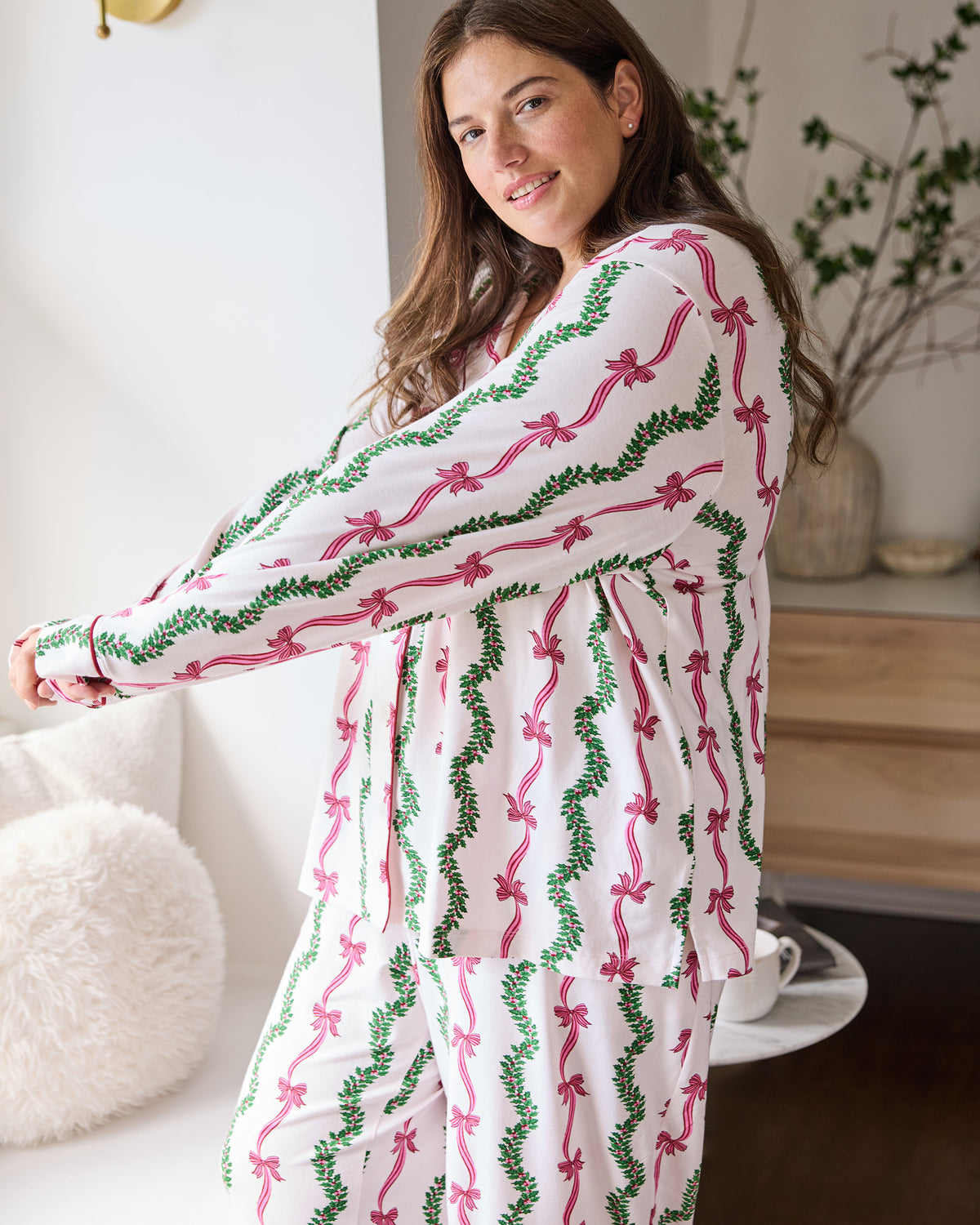 Close side view of the Ribbons & Bows button-down pajama set with pink bows and green garland print.