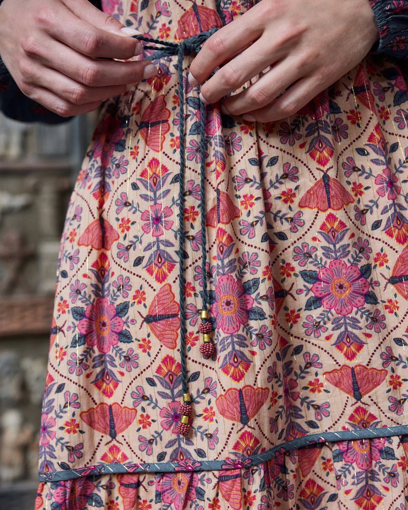 Close-up of the Eden Dress waist tie with bead accents and floral print.