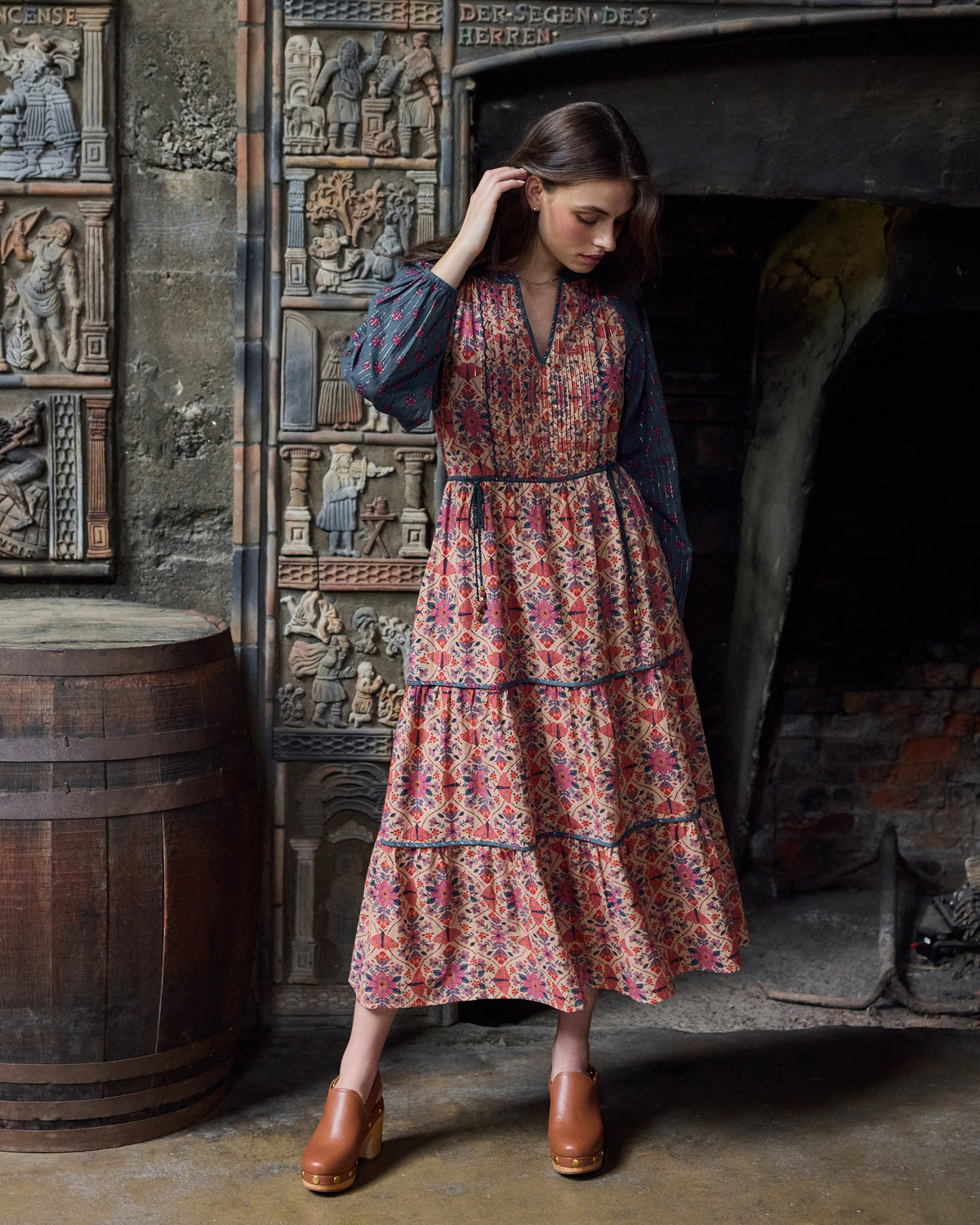 Three-quarter view of the Winged Tapestry Eden Dress showing its long sleeves, tiered skirt, and floral print.