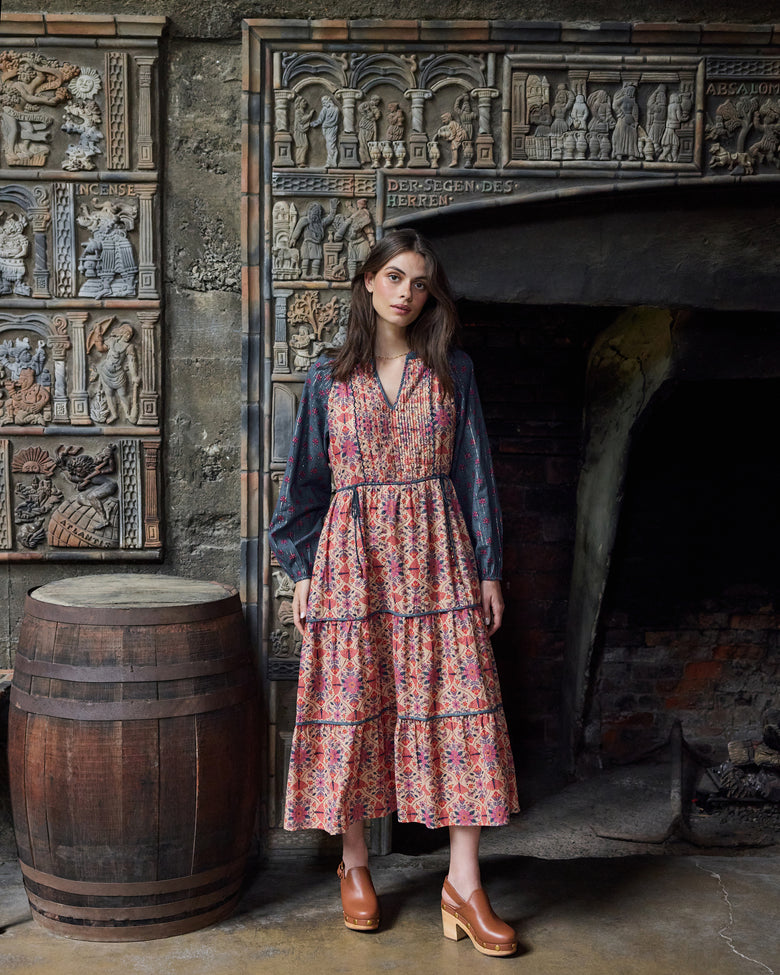 Front view of the Winged Tapestry Eden Dress with a tiered floral-print skirt and blue patterned sleeves.