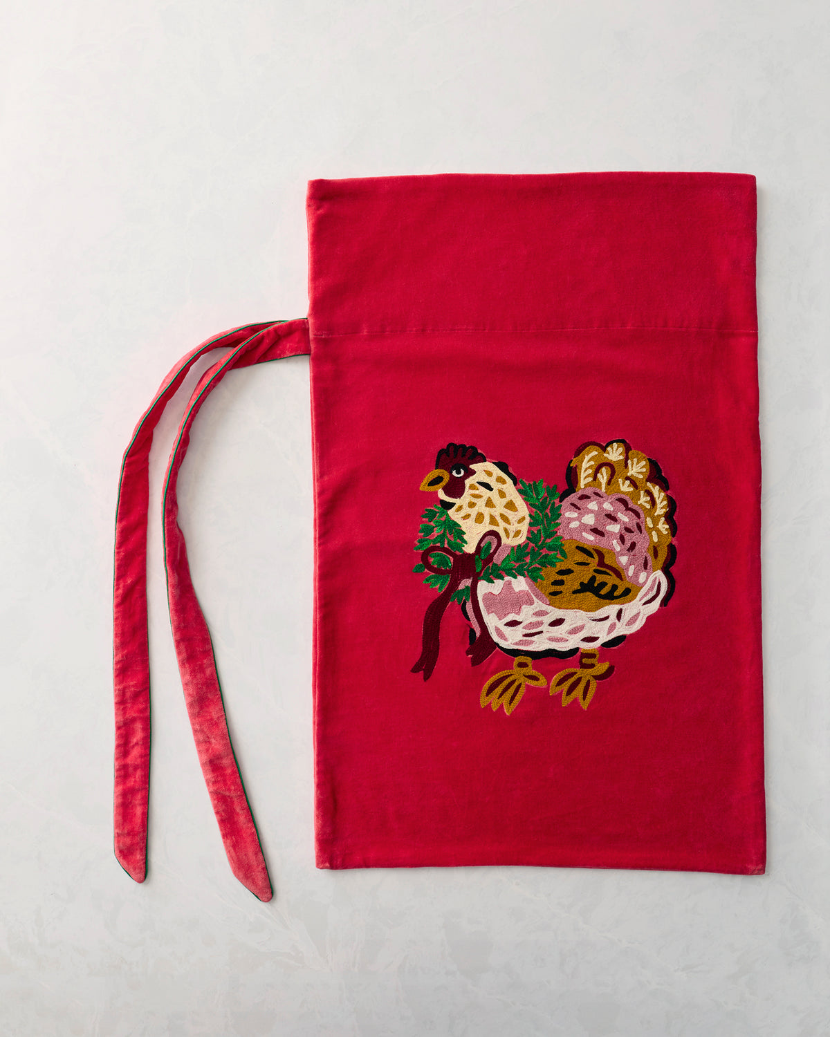 Flat view of a red gift sack with an embroidered hen carrying greenery and a bow, plus two ties.