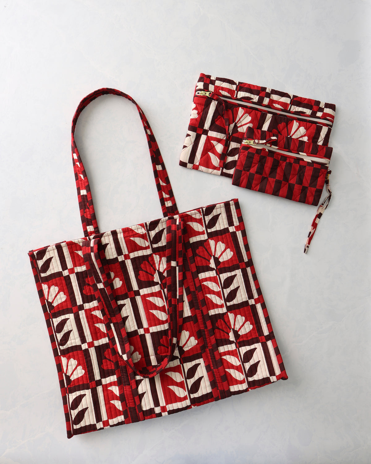 Bordeaux patterned tote and two matching zip pouches arranged at an angle.