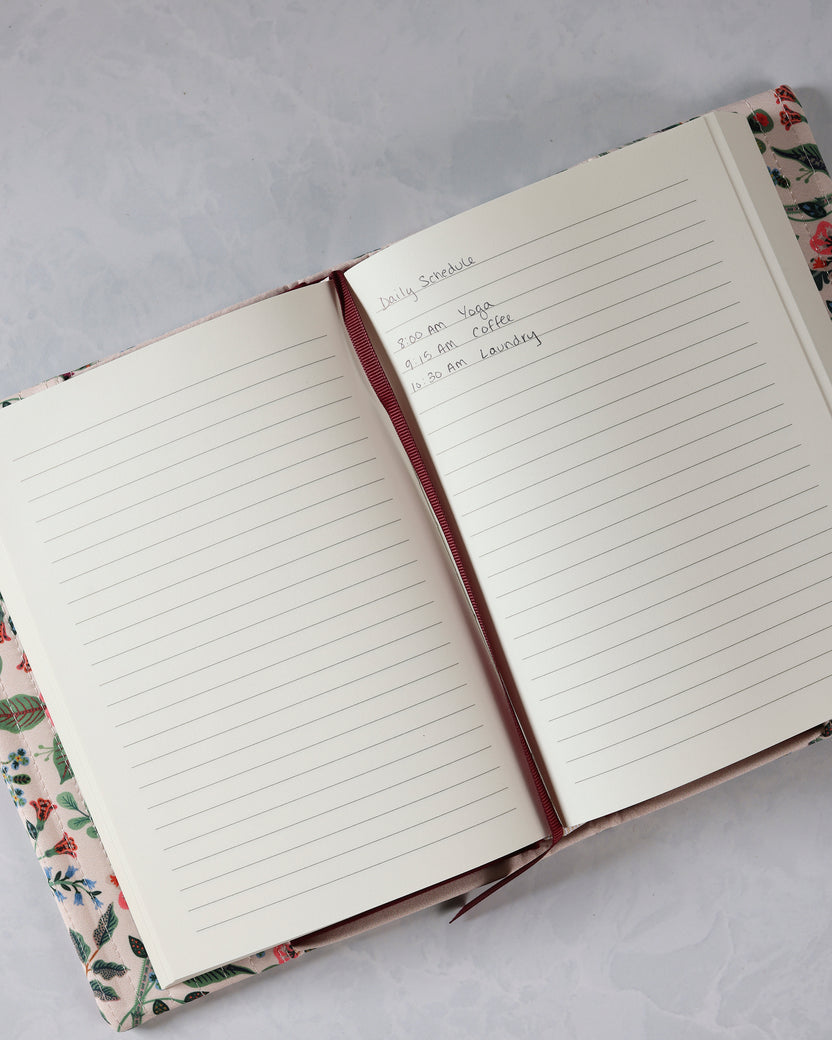 Open Gracie journal with lined pages, a ribbon bookmark, and handwritten schedule entries.