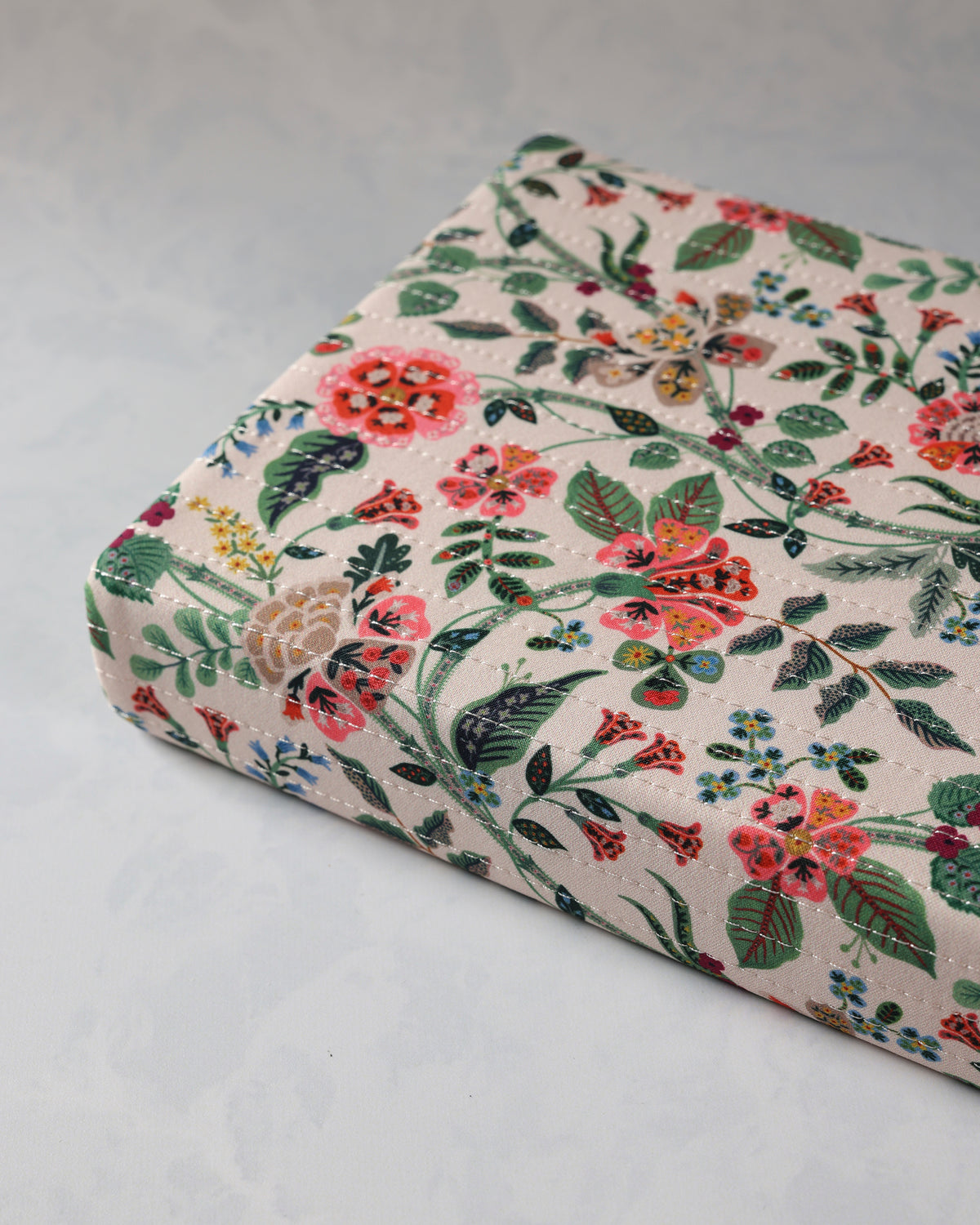 Close angled view of the Gracie journal showing its quilted floral cover and rounded corners.