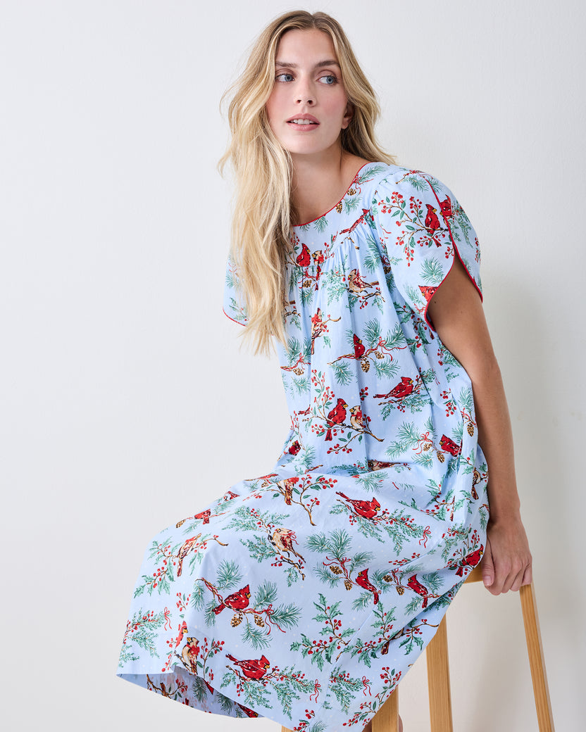 Front view of the Winter Cardinals Retro Dreams nightgown worn while seated, showing its short sleeves and bird-and-branch print.
