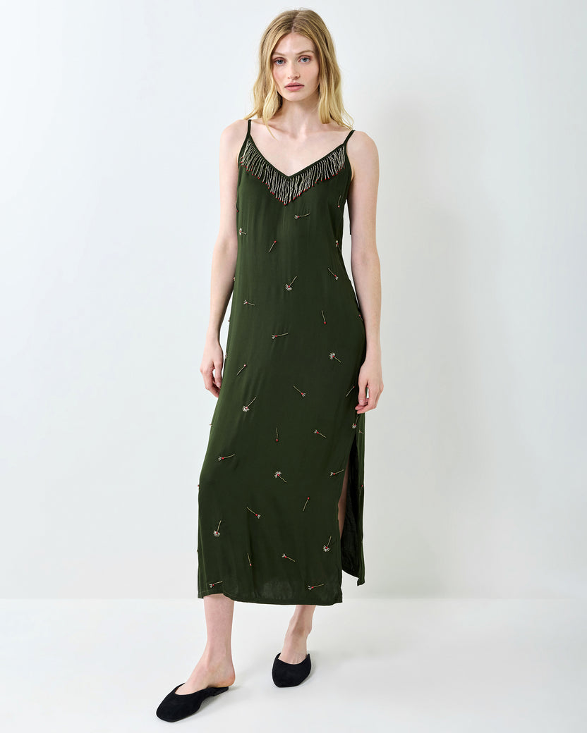 Full-length front view of the olive Matchmaker Melody slip dress with a beaded neckline, thin straps, scattered decorative motifs, and side slit.
