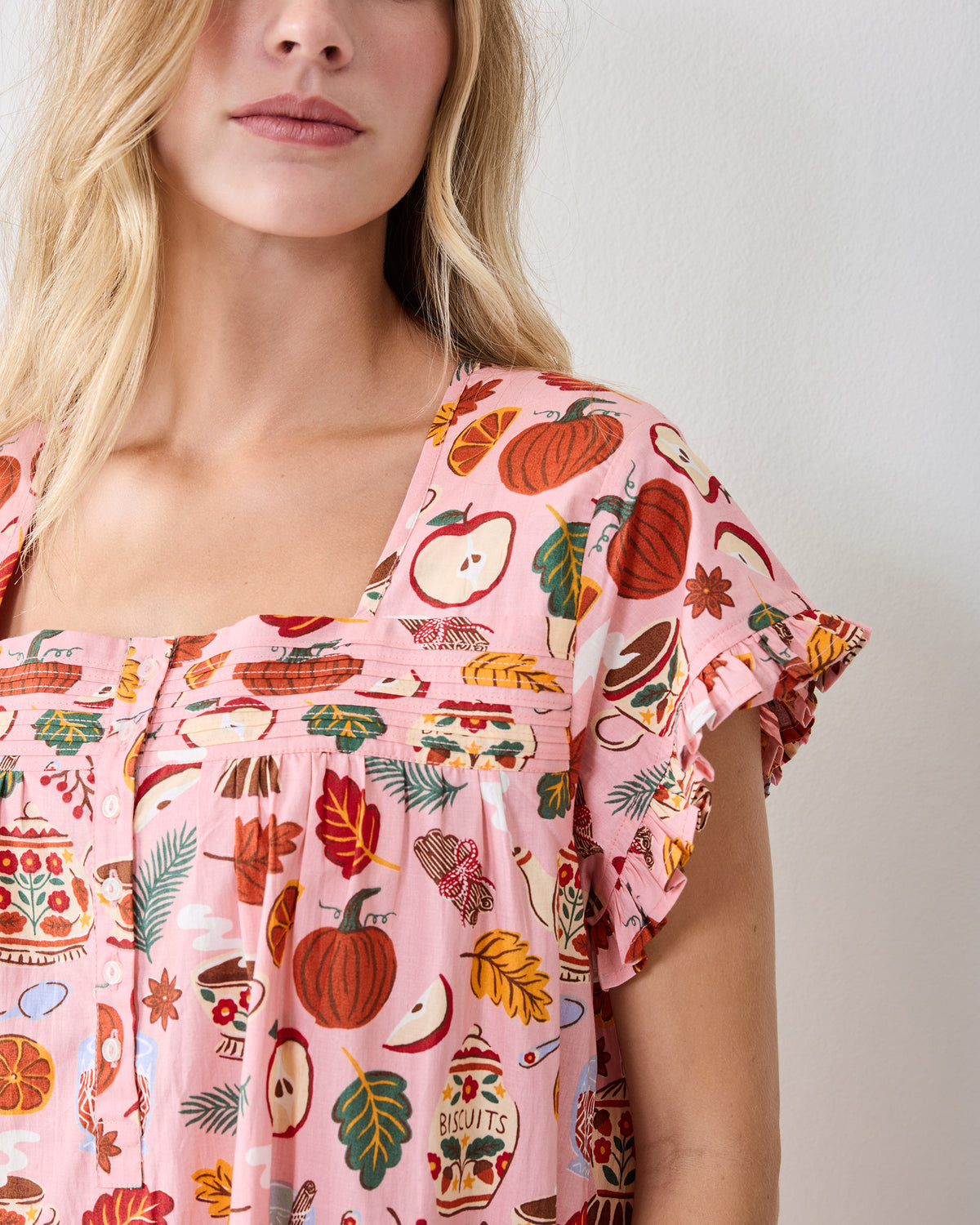 Close-up of the Autumn Cafe nightgown’s square neckline, button front, gathered yoke, and ruffled sleeve.