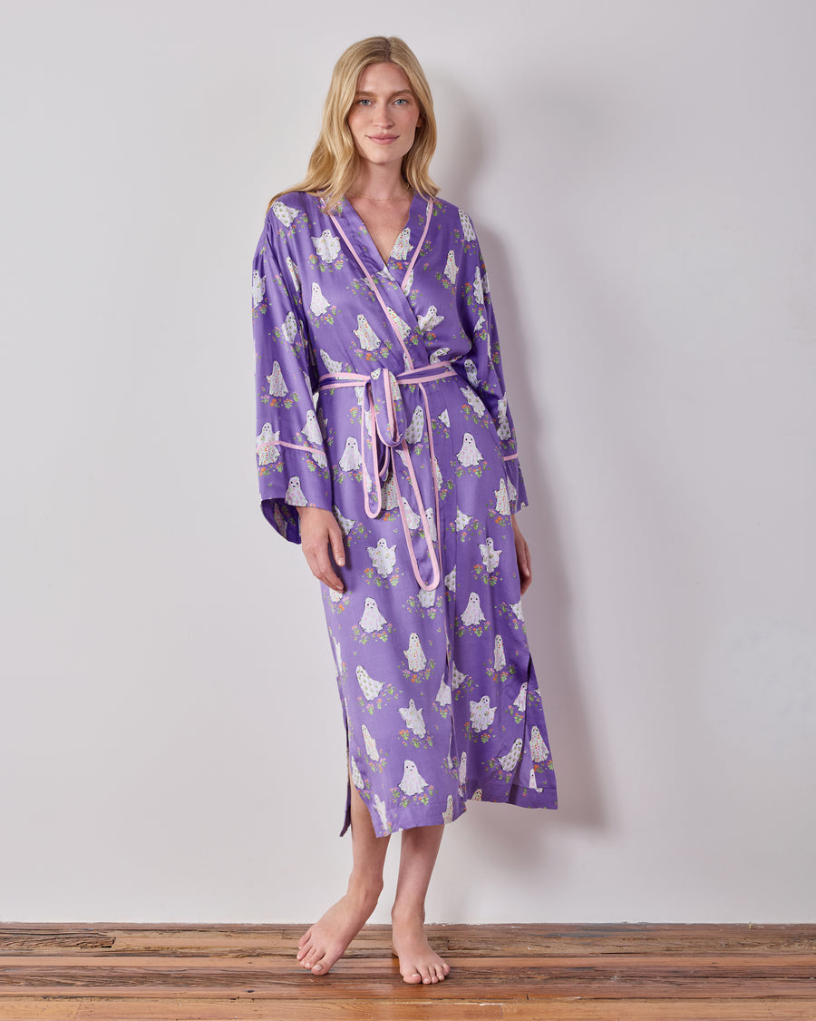 Full-length front view of a person wearing the purple ghost-and-floral print robe with a matching belt and pink trim.