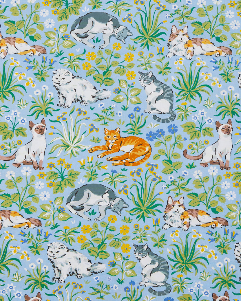 Light blue fabric swatch with a repeating pattern of cats, flowers, and green foliage.