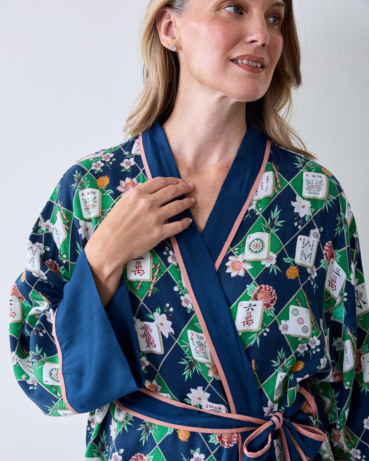 Front view of the Mahj Garden Eco Satin Robe in Wintergreen, featuring a floral mahjong-tile print, blue shawl collar and cuffs, pink trim, and a waist tie.