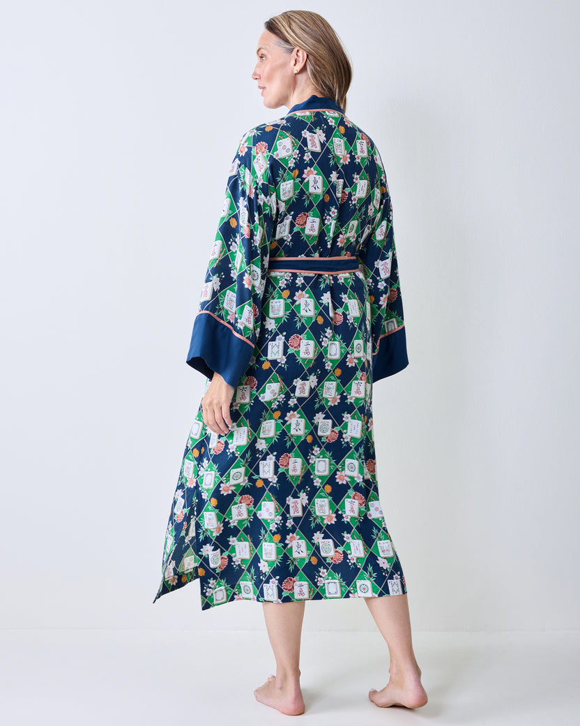 Back view of the wintergreen Mahj Garden robe showing the full floral and label pattern, dark blue cuffs, and waist tie.