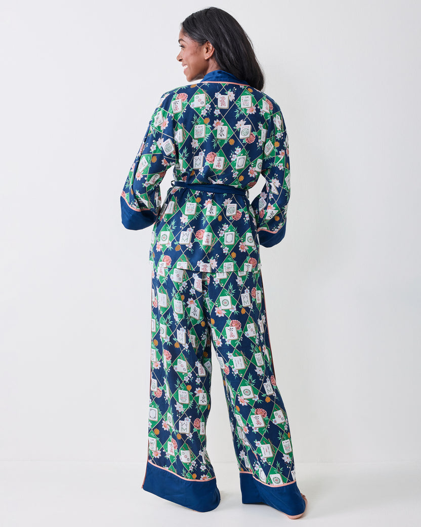 Back view of the Mahj Garden Eco Satin Wrap Set in Wintergreen, showing the tied waist, long sleeves, wide-leg pants, and floral mahjong-tile print.
