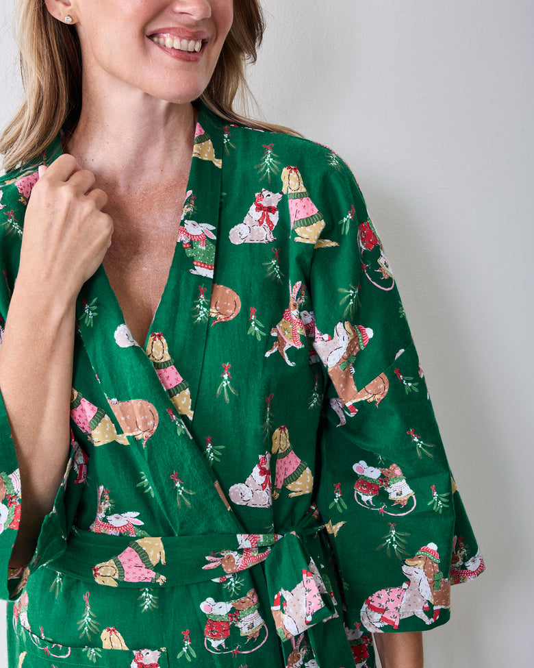 Close view of the green Mistletoe Kiss robe showing the wrap front, holiday critter print, matching belt, and sleeve detail.