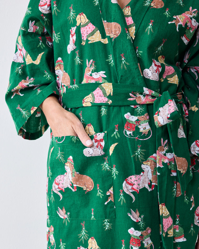 Close view of the green Mistletoe Kiss robe showing its waist belt, deep side pocket, sleeve, and holiday critter print.