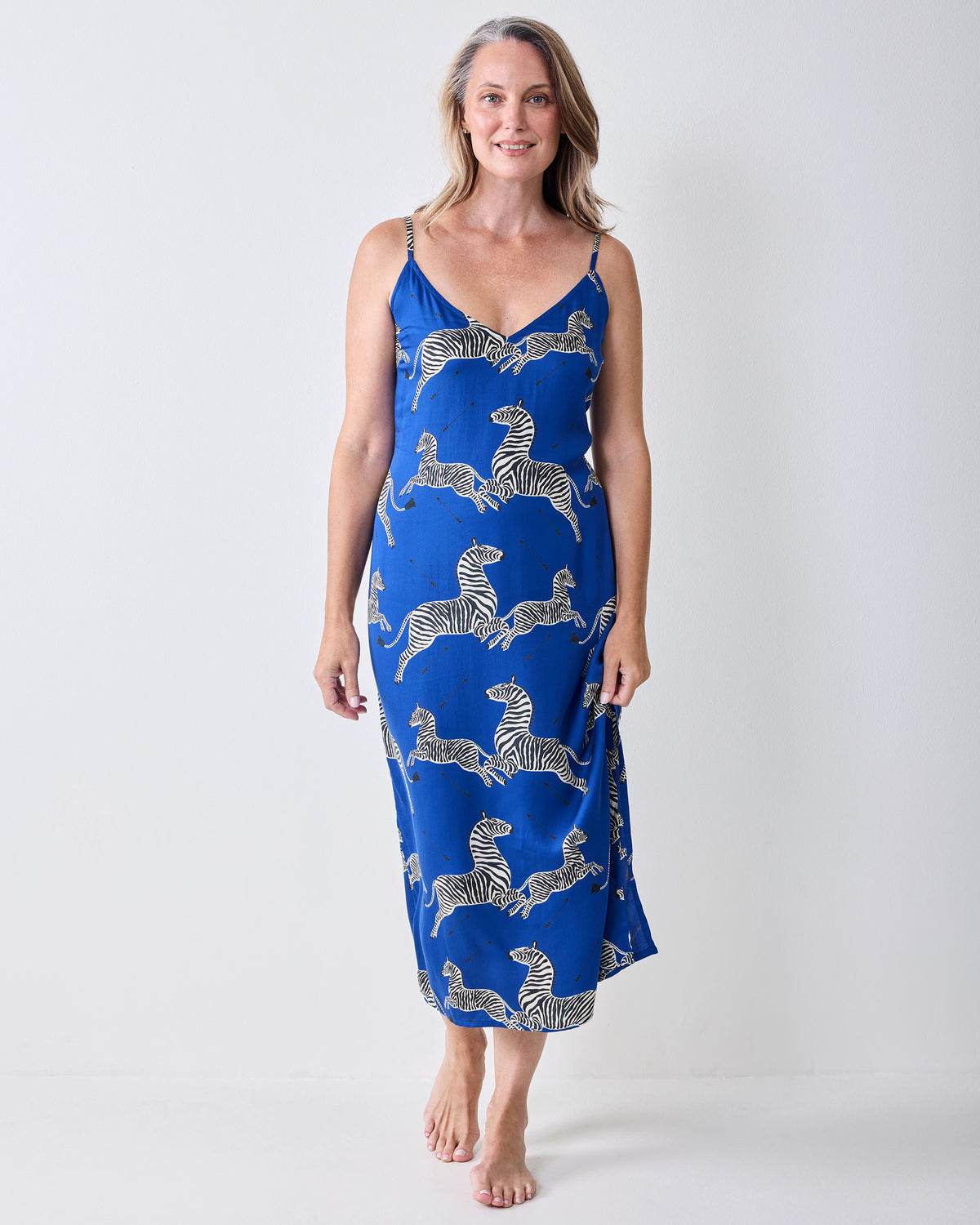 Front view of a denim-blue zebra-print nightie with thin shoulder straps and a mid-calf hem.