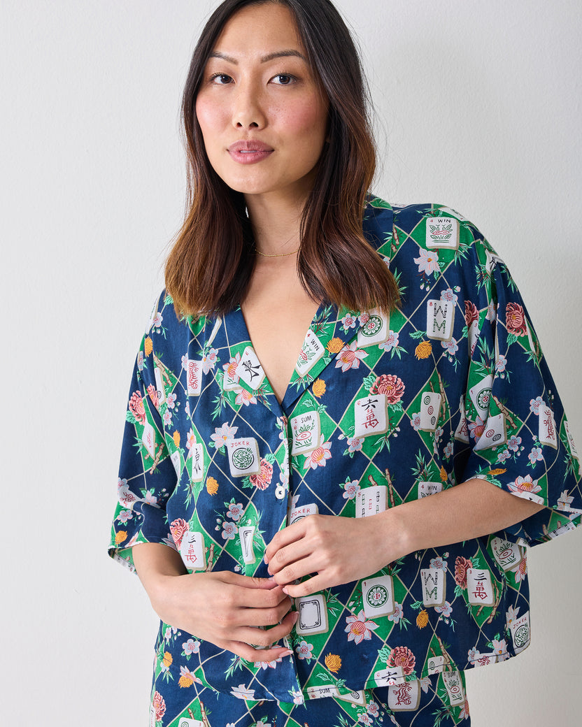 Front view of a person wearing the Mahj Garden Sweet Dreams set, a short-sleeve patterned button-front top with matching shorts.