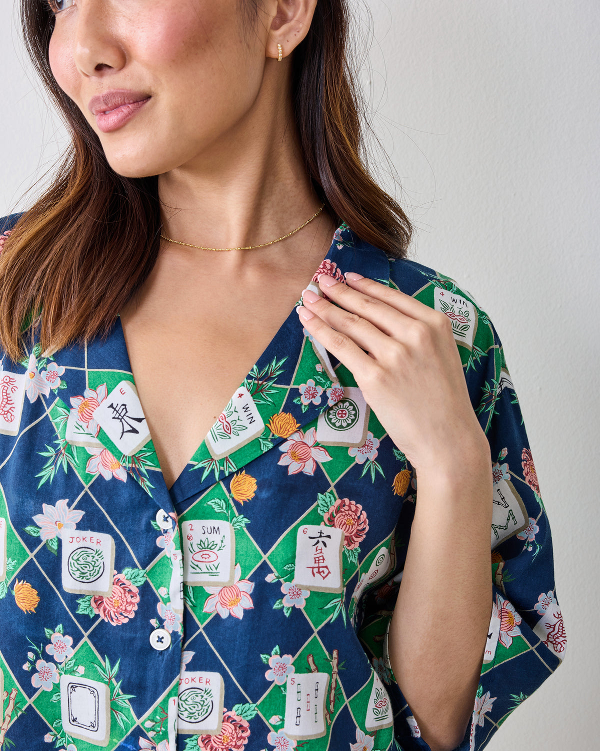Front close view of the Mahj Garden Eco Satin Sweet Dreams Set in Wintergreen, showing a short-sleeved button-front top with a floral mahjong-tile print.