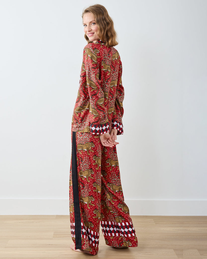 Back and side view of the scarlet satin pajama set, showing the long-sleeved shirt and wide-leg pants with geometric trim at the cuffs.