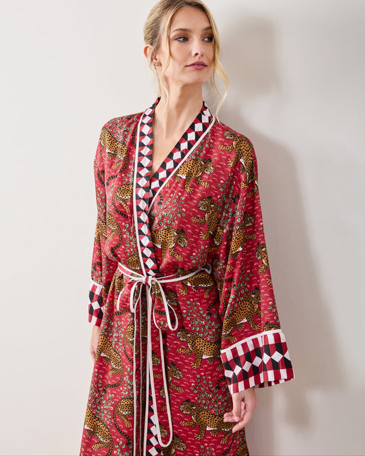 Front view of a person wearing the scarlet Bagheera robe with leopard print, geometric trim, and a tie belt.