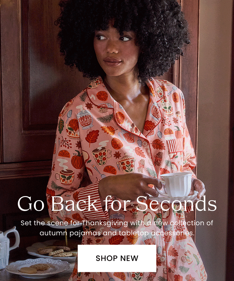 Person in patterned pajamas holding a cup and saucer beside a table of pastries; banner reads “Go Back for Seconds,” “Set the scene for Thanksgiving at home with a new collection of autumn pajamas and tabletop accessories,” and “SHOP NEW.”