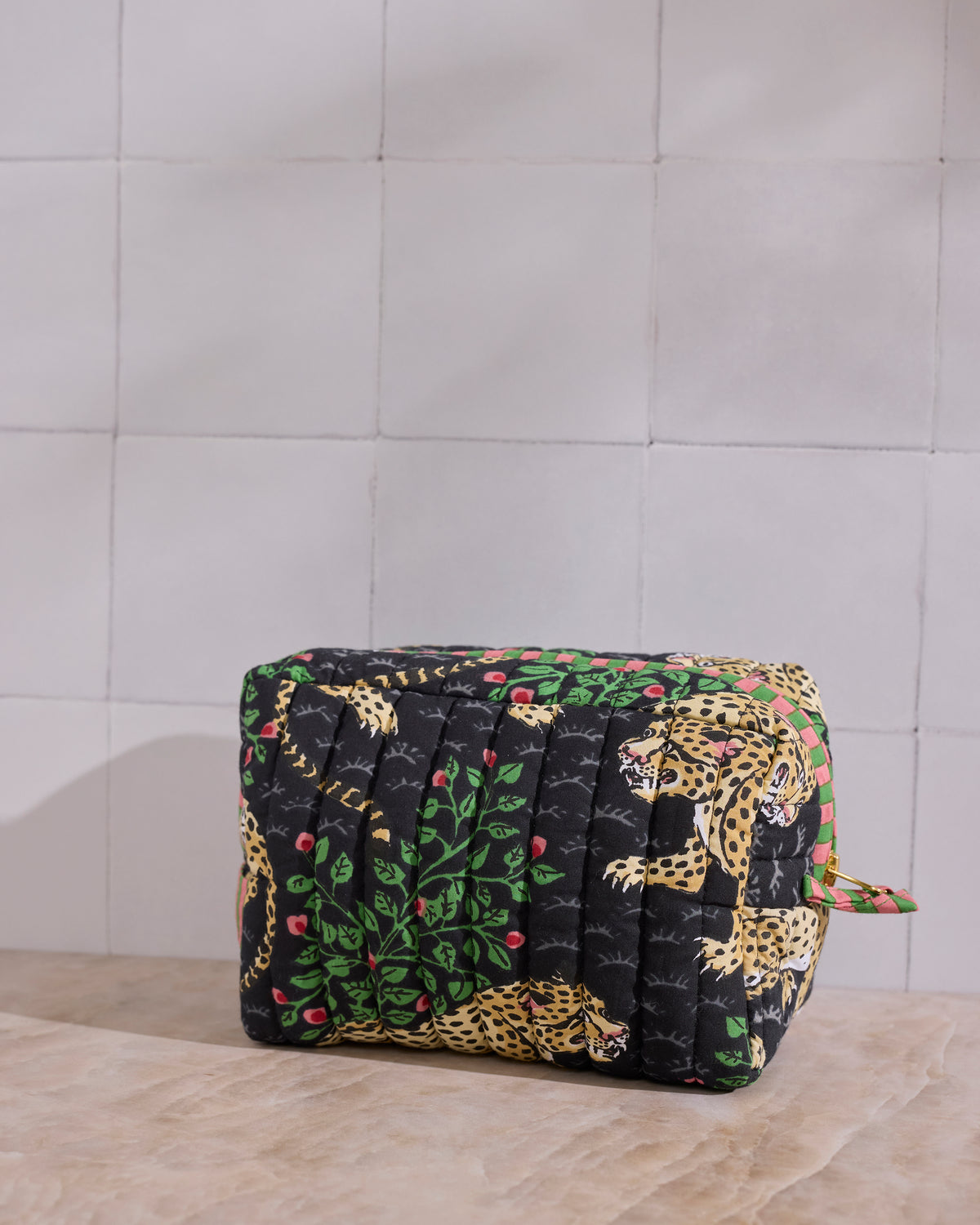 Rear angled view of the Ink Bagheera quilted pouch, showing the padded quilting and leopard-and-leaf print.