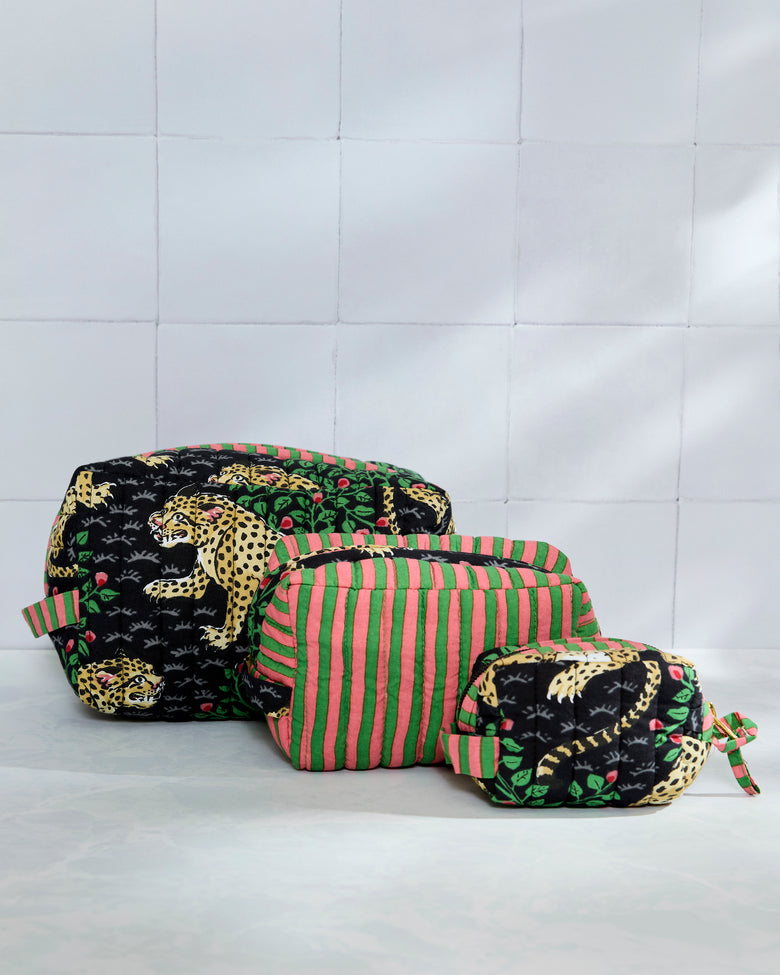 Three quilted pouches arranged by size, with leopard print on the largest and smallest pouches and pink-and-green stripes on the middle pouch.