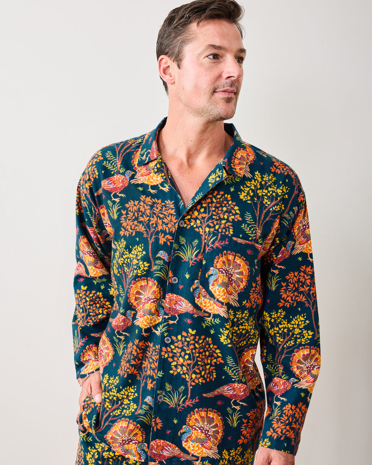 Close front view of the navy Turkey Trot long pajama shirt with colorful turkey and autumn foliage print.