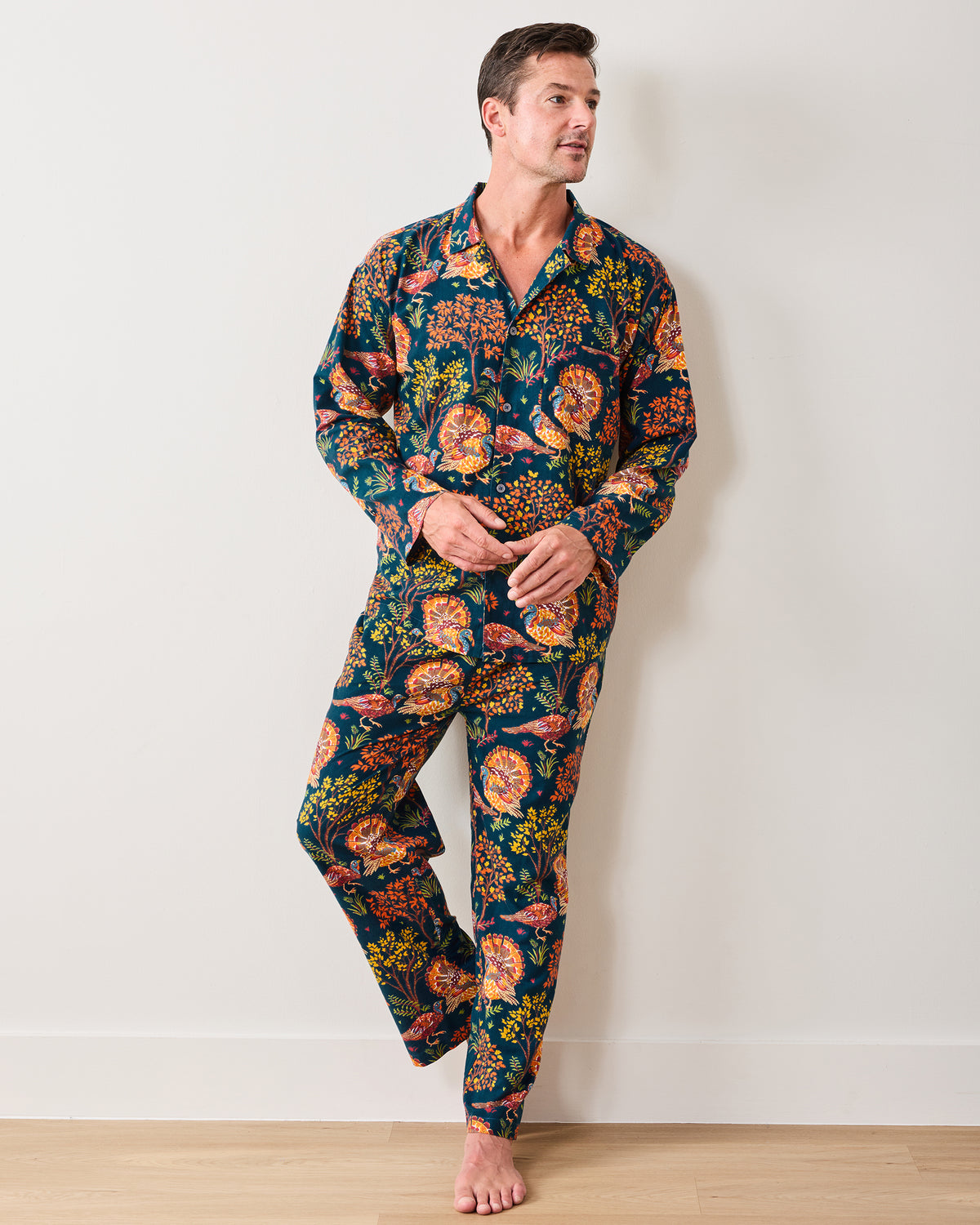 Front three-quarter view of the Turkey Trot navy long pajama set with a button-front shirt and matching turkey-and-floral print pants.