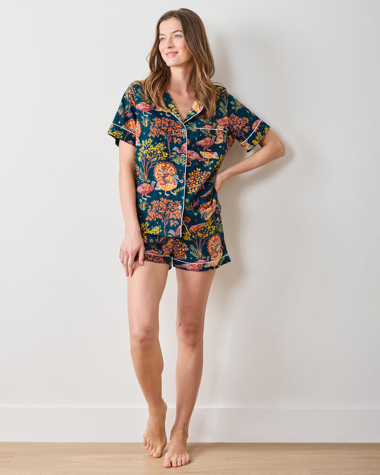 Full-length view of the navy Turkey Trot short pajama set with a button-front top and matching shorts, shown from a slight side angle.