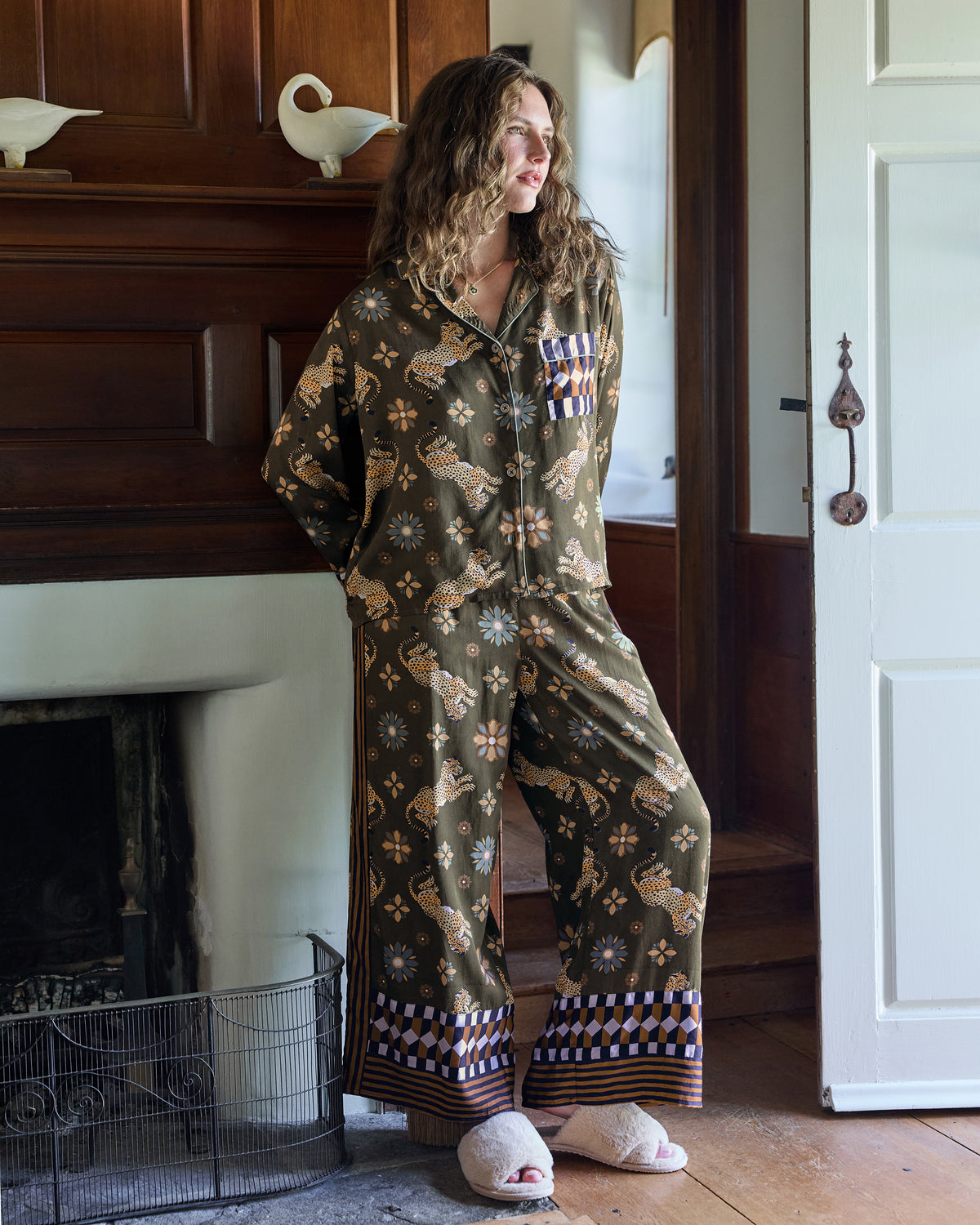 Olive pajama set with a long-sleeve button-front top and wide-leg pants printed with leopards and flowers.