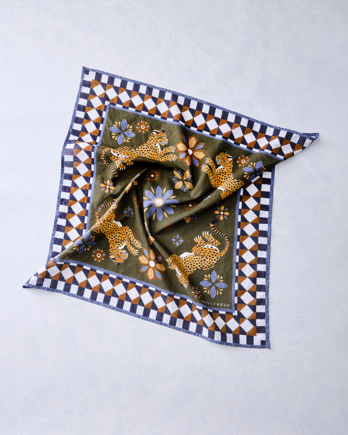 Olive square bandana scarf arranged in soft folds, showing four leopards, flowers, and a geometric border