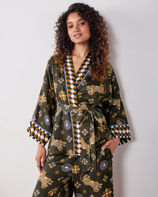 Front view of the olive Wrap Set with a belted wrap top, patterned trim, and matching pants featuring leopard and flower prints.