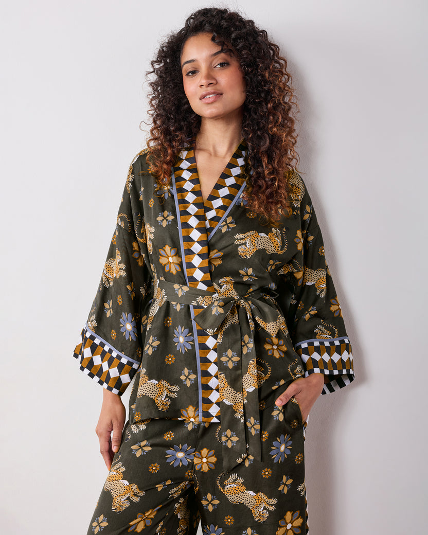 Front view of the olive Wrap Set with a belted wrap top, patterned trim, and matching pants featuring leopard and flower prints.