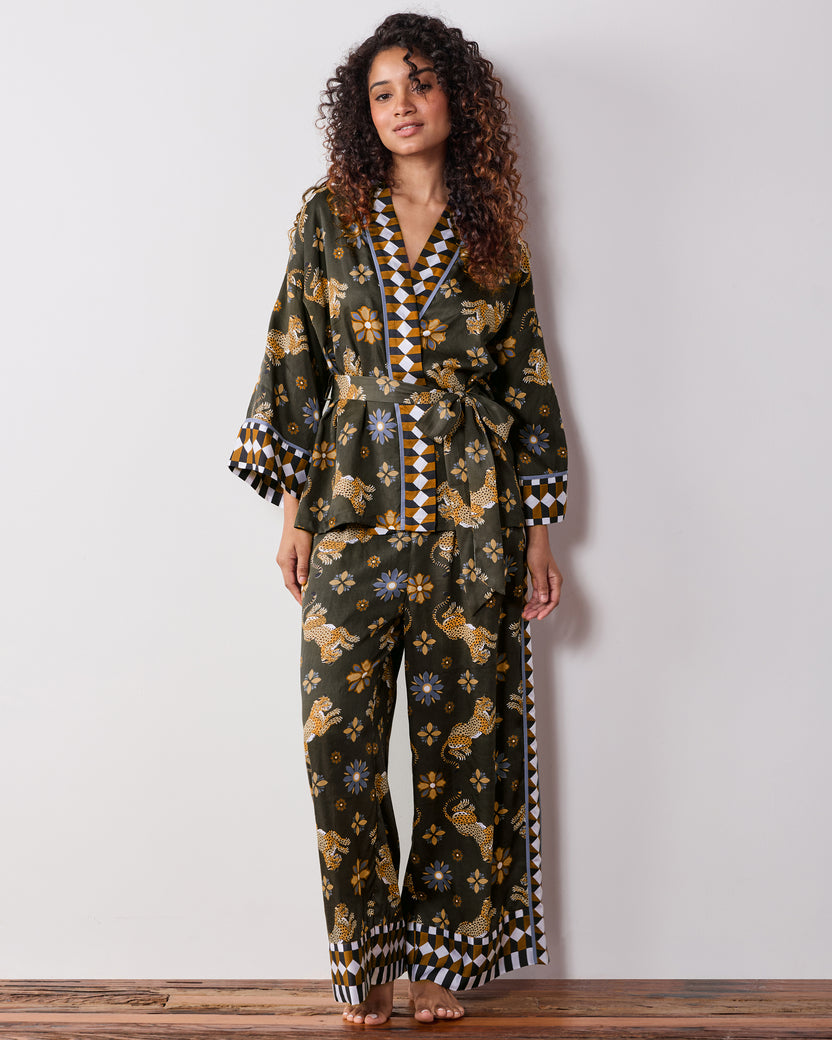 Front view of a person wearing the olive Bagheera Kaleidoscope wrap set, showing the leopard-and-flower print and geometric trim.