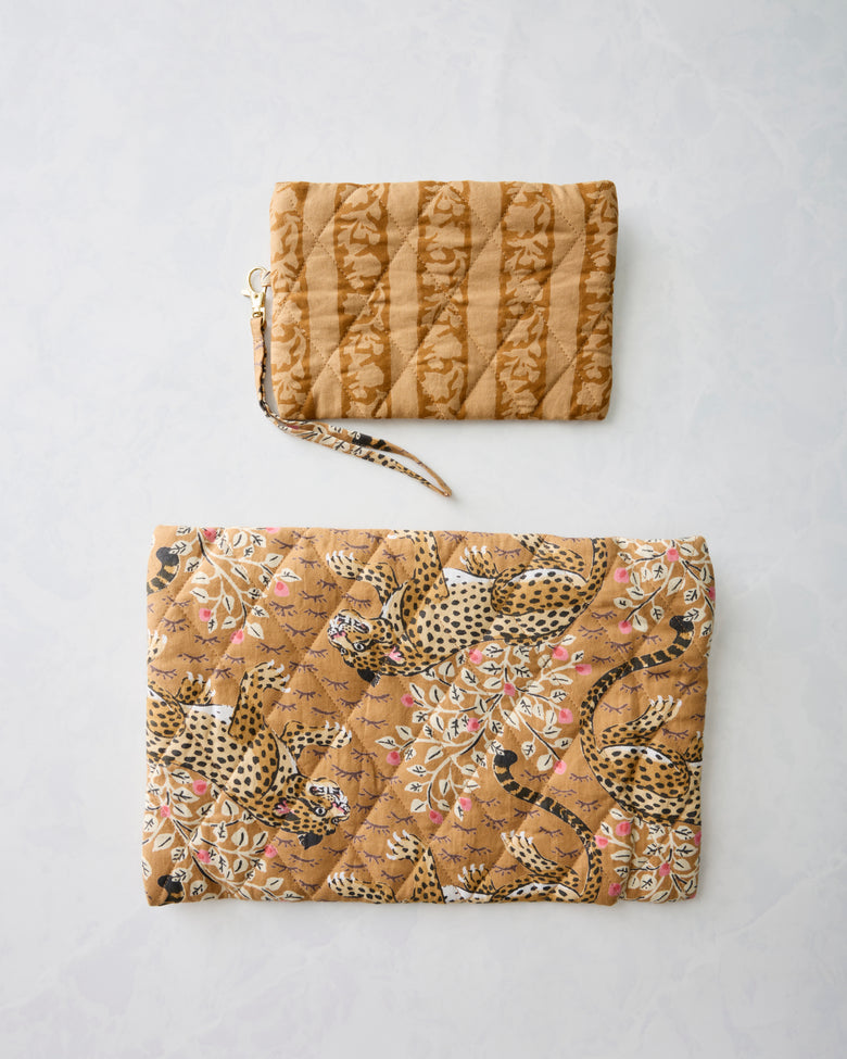 Two brown quilted pouches displayed separately, with a striped animal print on the smaller pouch and a leopard print on the larger pouch.