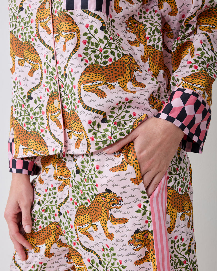 Close-up of the Bagheera pajama set showing the printed top, checkered cuff, button front, and side pocket.